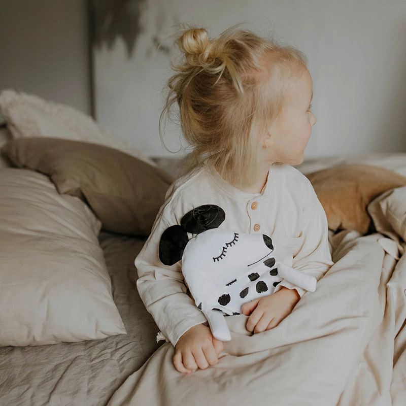 A soft unbranded stuffed animal placed on a clean bedside table to represent a comfort plush for calming moments