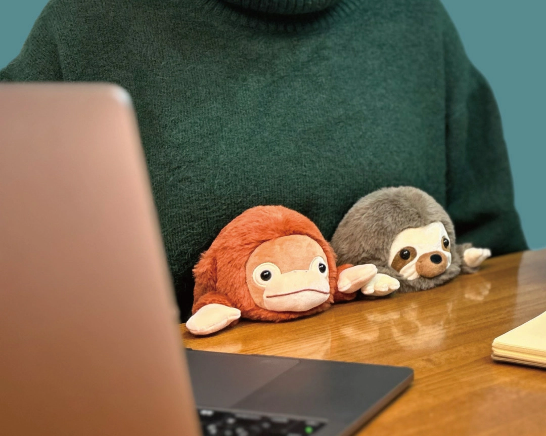 Branded promotional plush toy being received at a corporate event to support audience engagement, gifting and continued brand visibility