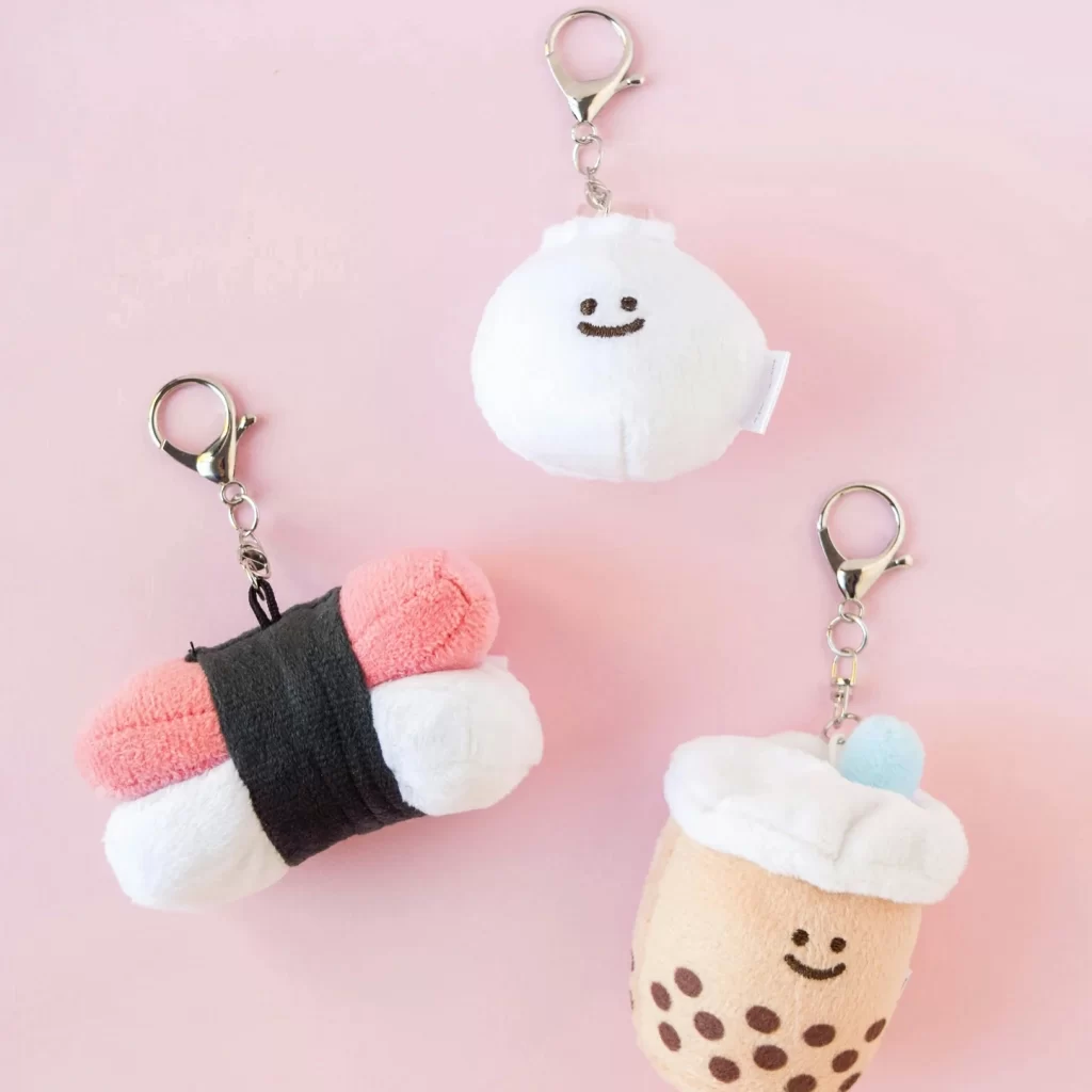 A group of unbranded mini plush charms showing animal, food, mascot, and seasonal concepts