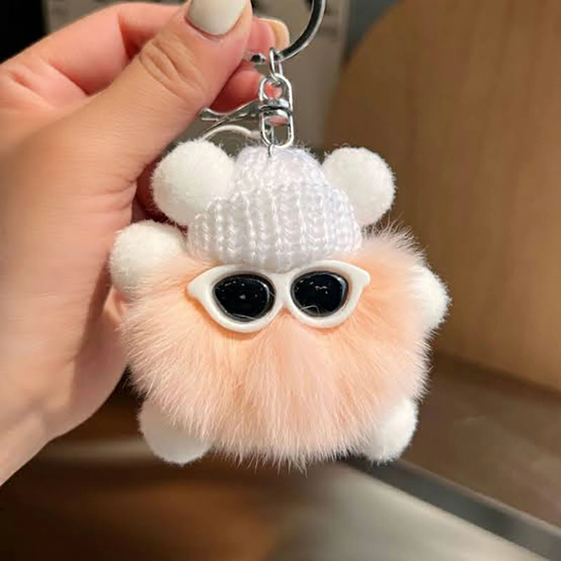 Plush charm prototypes hanging from sample hooks to compare attachment position and balance